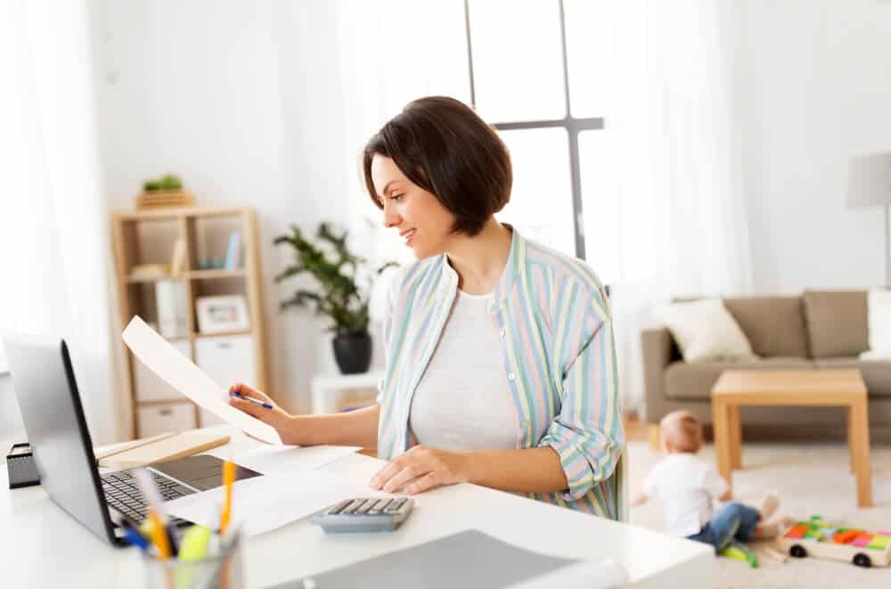 young woman filing 2020 taxes in a laptop