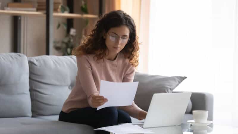 hispanic woman looking at car insurance policy terms