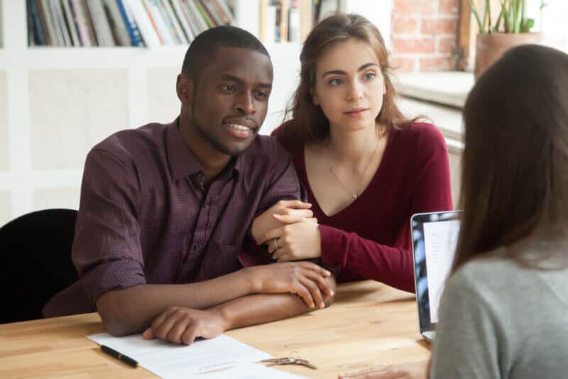 couple discussing life insurance policy with insurance agent