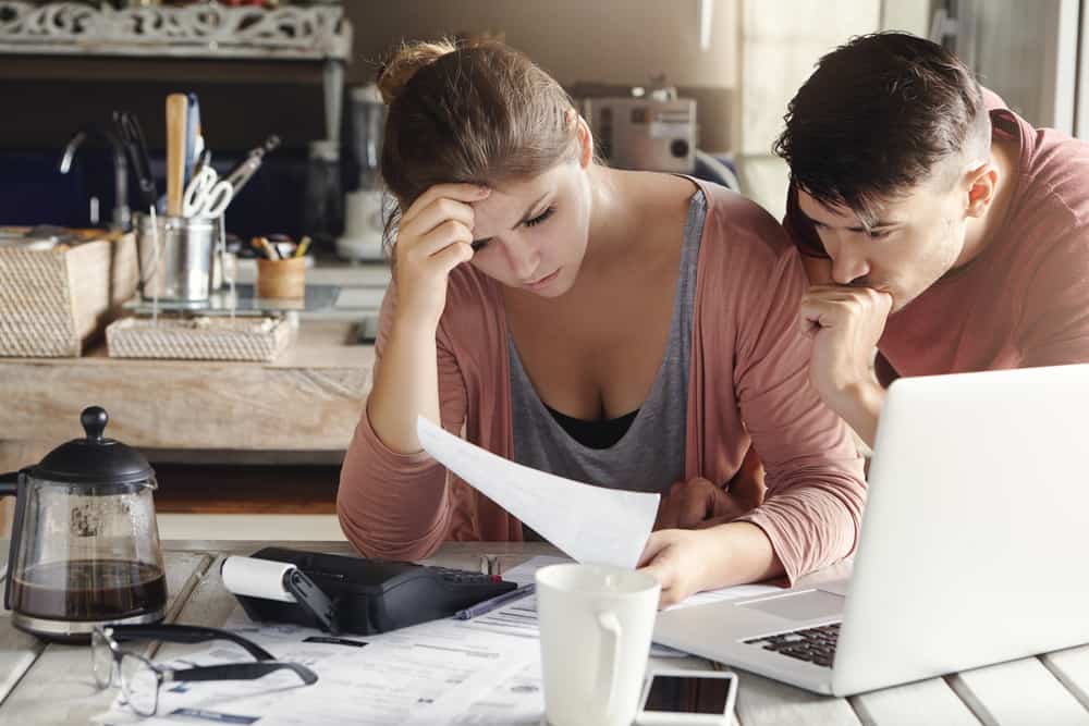 distressed couple going over business papers