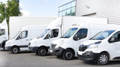 group of white vans lined up