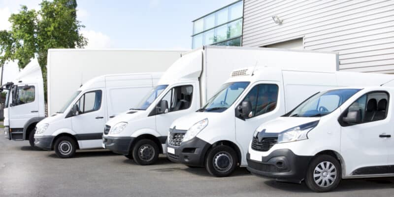 group of white vans lined up