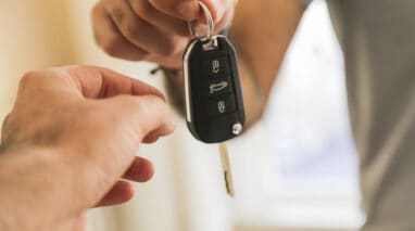 person handing over car keys