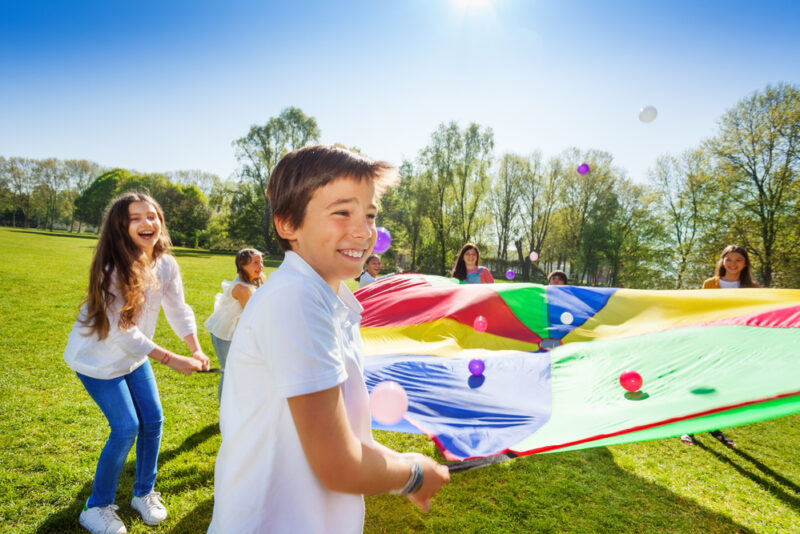 Kids playing bounce the balls at summer camp