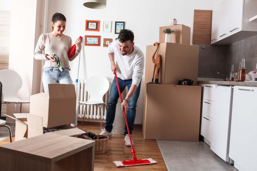 Young couple cleaning their new apartment