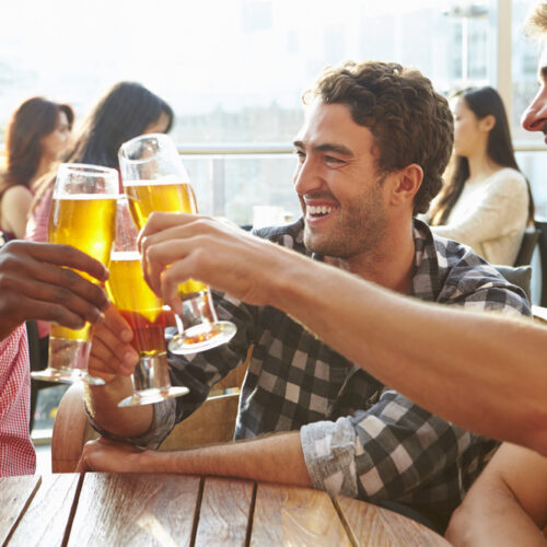 Male friends out having a beer in the bar - cheap DUI insurance in Washington