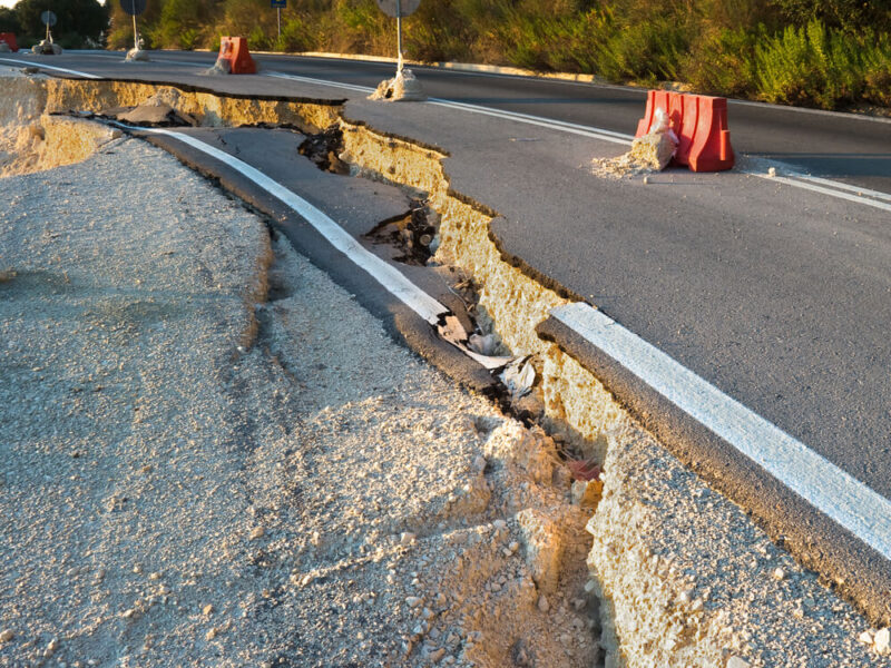 An image of a crack in the road showing an earthquake line.