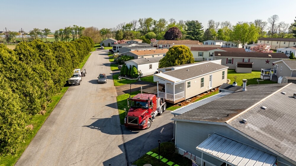 Affordable mobile home being set up on a lot in a park 