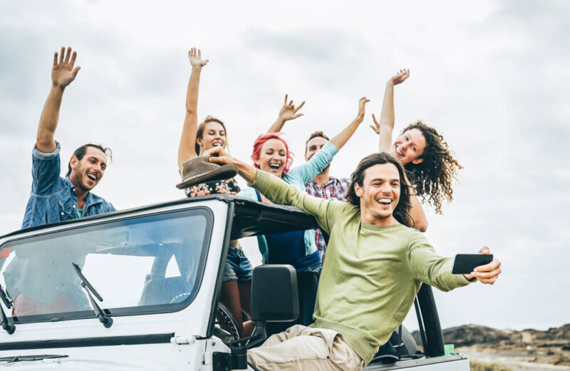 Group of Generation Z friends on a convertible truck, having fun and taking a photograph - Vern Fonk, affordable car insurance in Washington