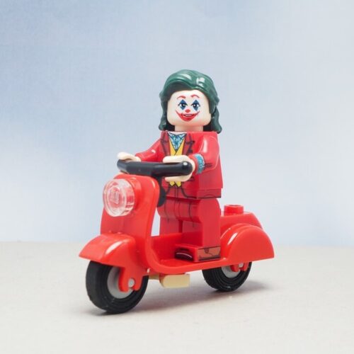 Mini toy of the Jocker driving a red motorcycle with blurred background - Vern Fonk, cheap homeowners insurance in Pacific Northwest