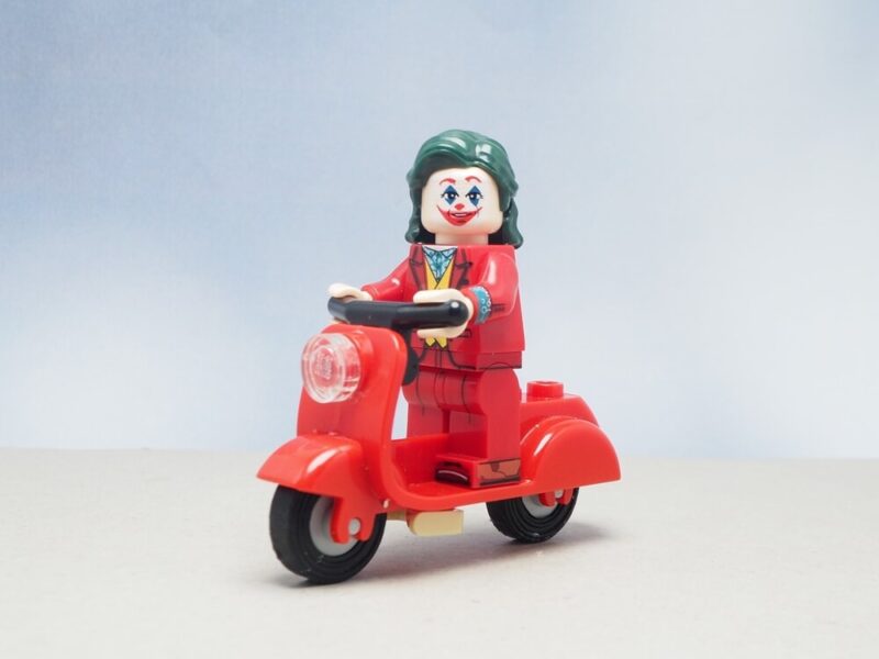 Mini toy of the Jocker driving a red motorcycle with blurred background - Vern Fonk, cheap homeowners insurance in Pacific Northwest